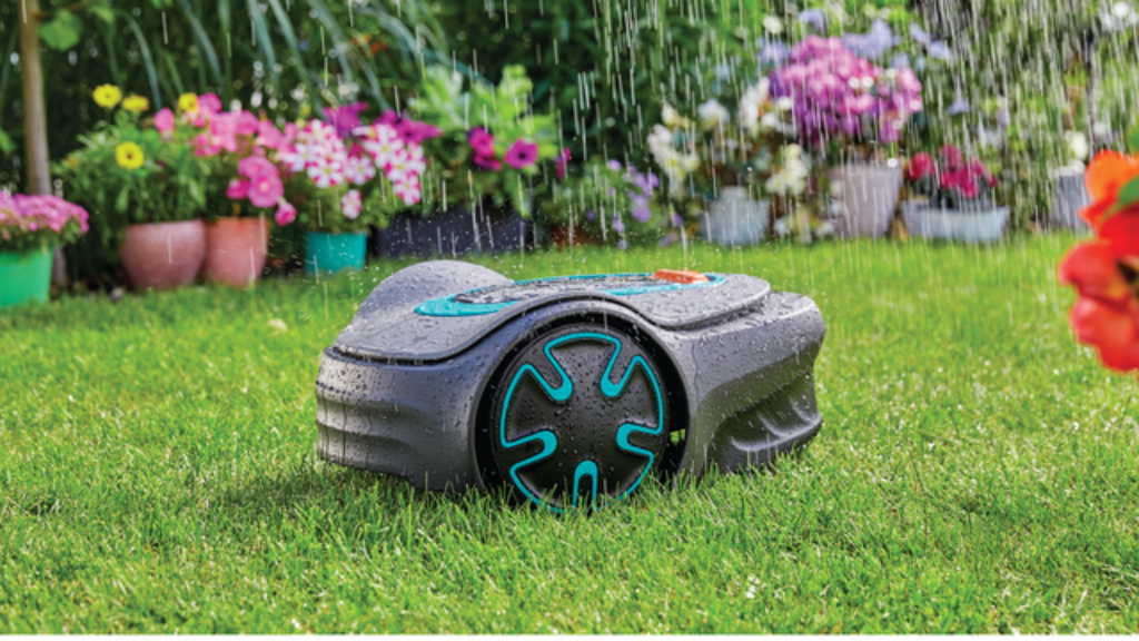 A robotic lawn mower, Gardena Sileno minimo, sits on a lush green lawn in the rain.