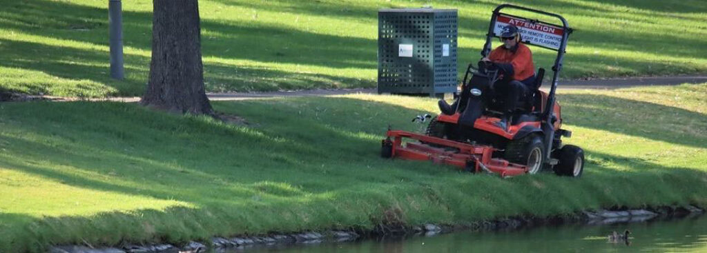 A person mowing a grass