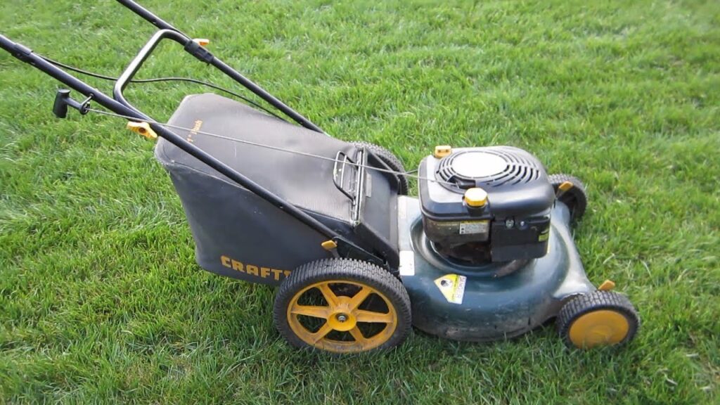 A red Craftsman lawn mower sitting on a lush green lawn.